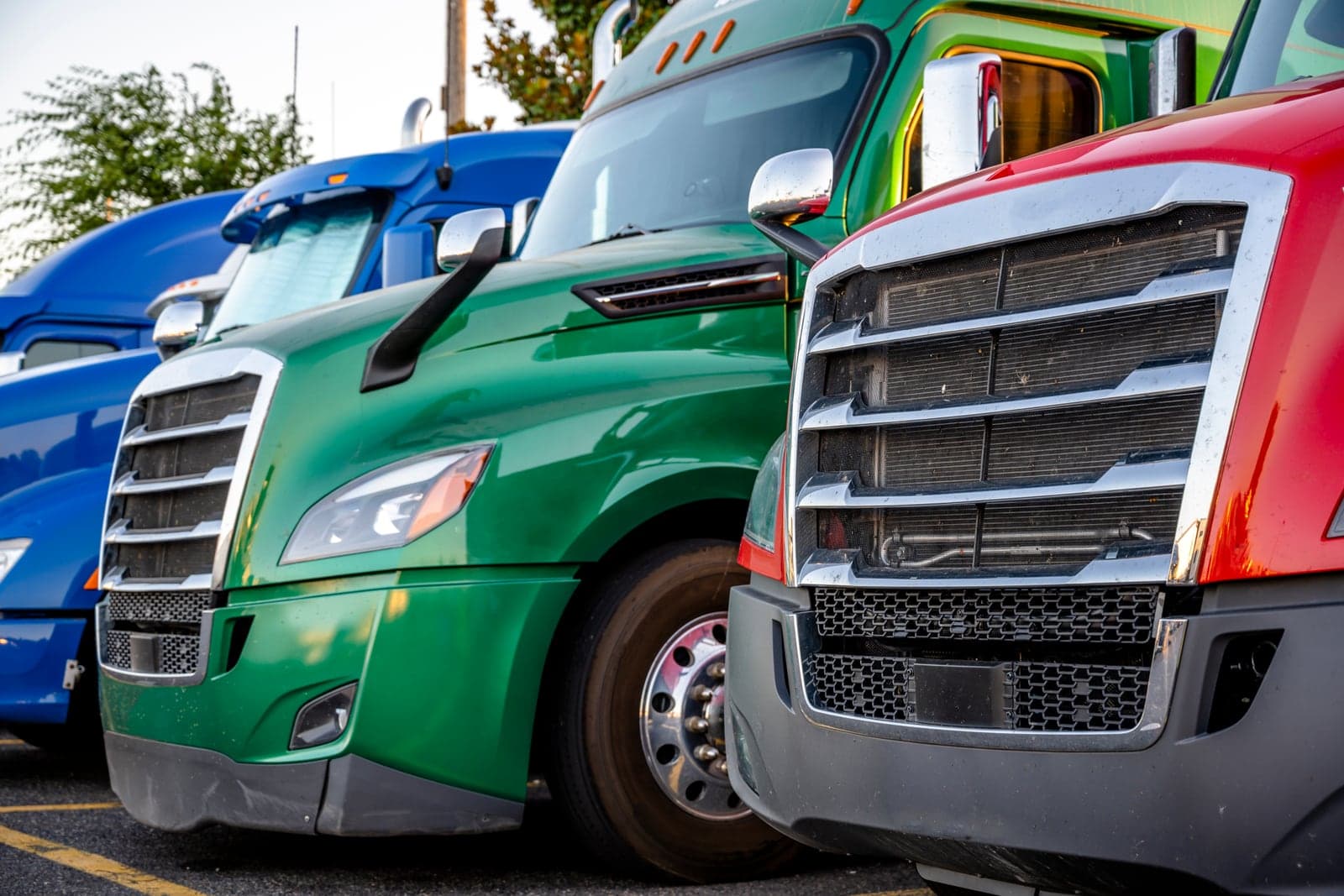 A lineup of branded semi trucks parked side by side