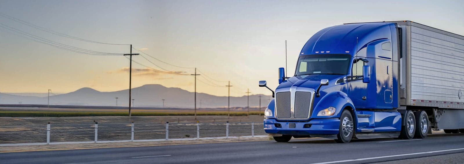 Semi truck on the highway at sunset